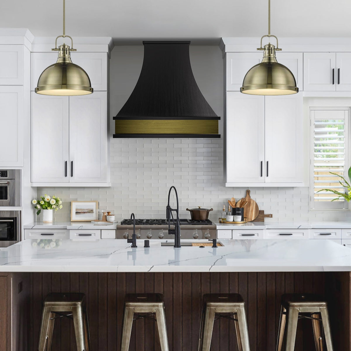 Modern kitchen with white cabinets, black range hood, and brass pendant lights.