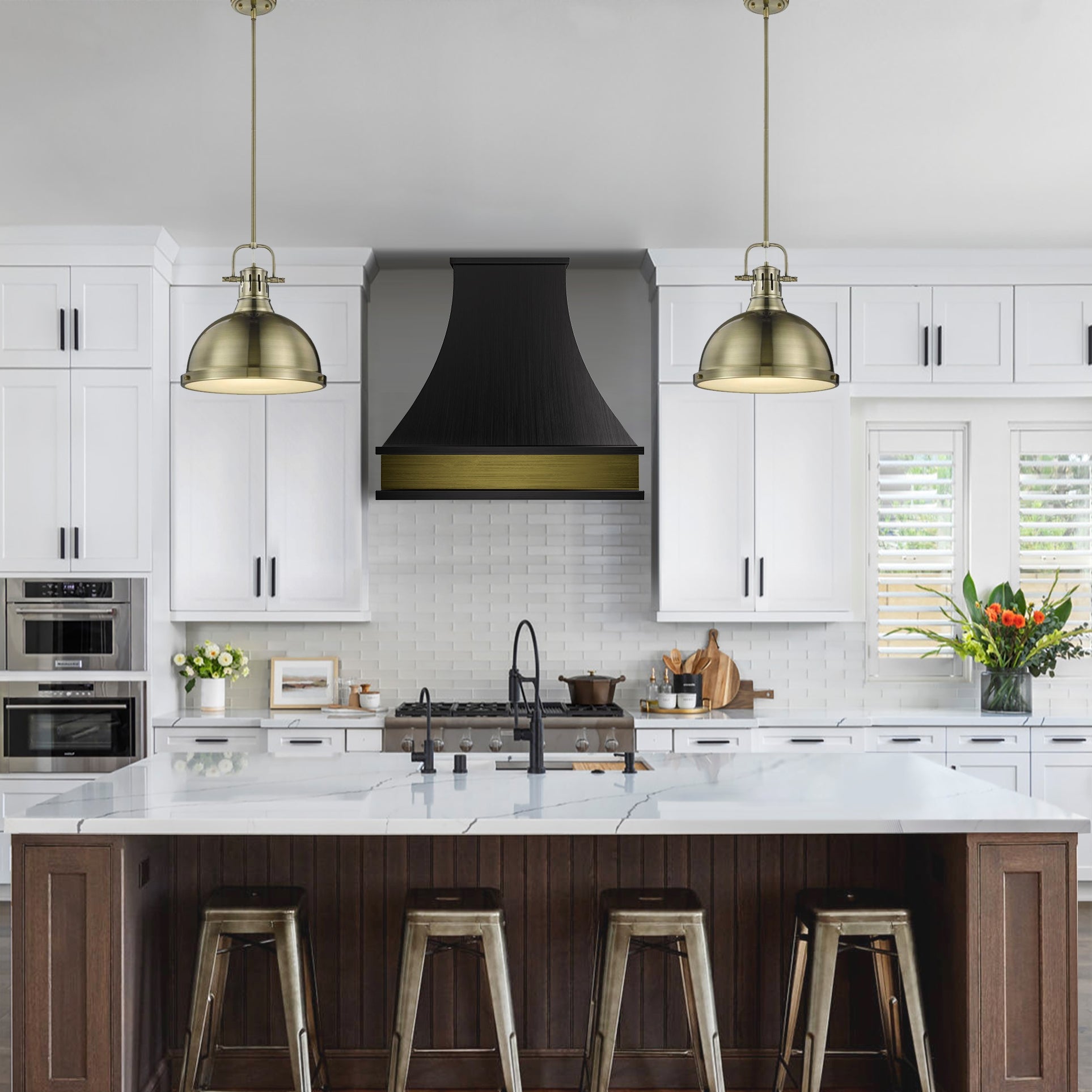 Modern kitchen with white cabinets, black range hood, and brass pendant lights.