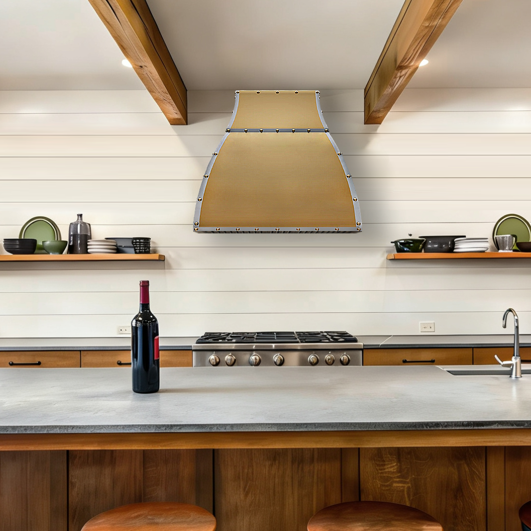 a custom brass range hood in a modern kitchen