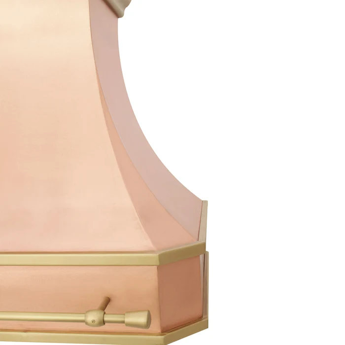 close-up of a curved copper range hood with a brass pot rail