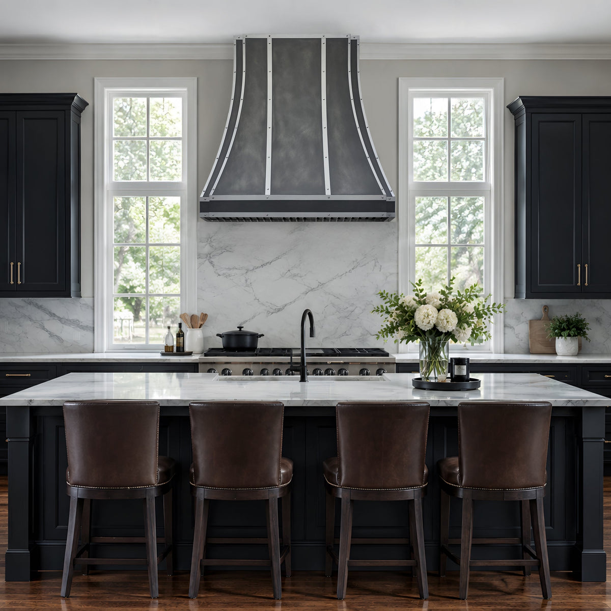 zinc range hood in a luxury kitchen interior featuring dark charcoal/black cabinets