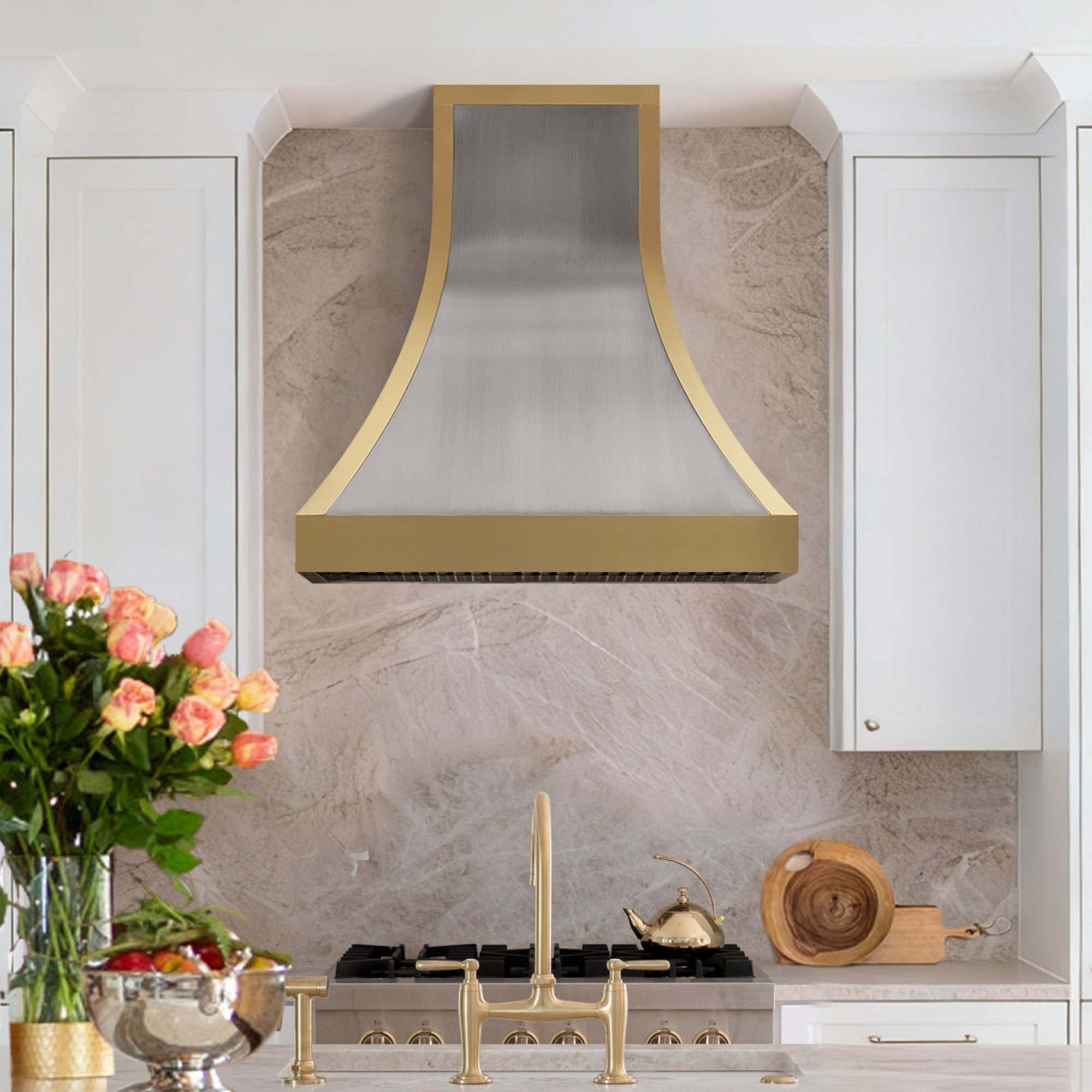 Modern kitchen with Stainless range hood, marble backsplash, and decorative elements.