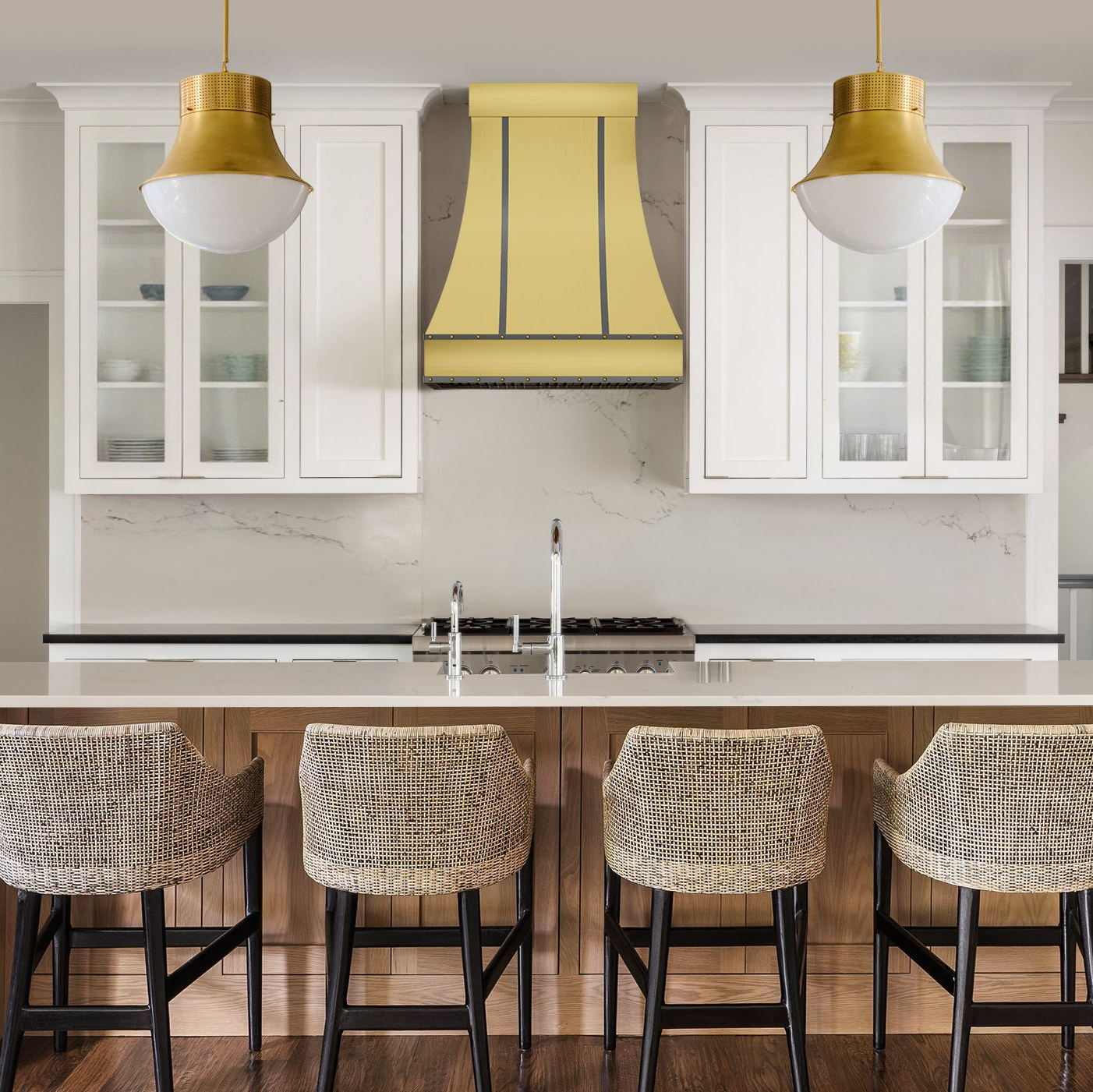 Modern kitchen with white cabinets, yellow range hood, and wooden dining table with chairs.