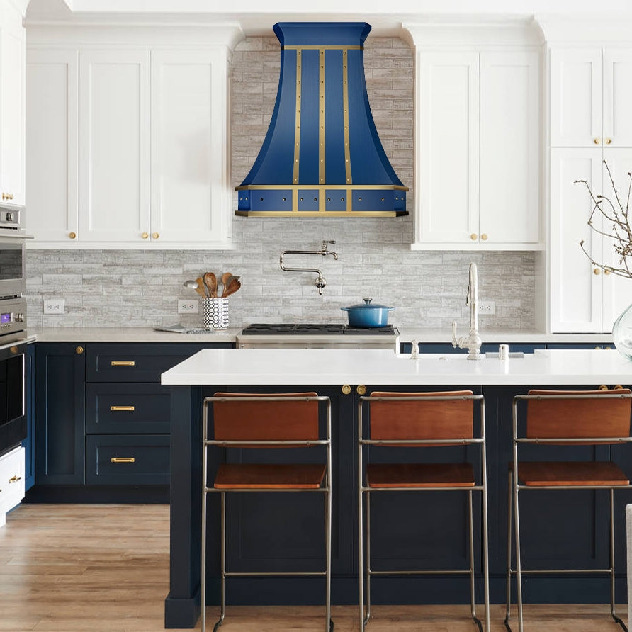 Modern kitchen with blue range hood, white countertops, and wooden stools.