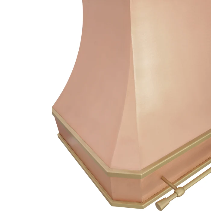 close-up of a custom copper range hood with a brass trim and a small brass rod